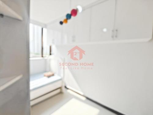 a white refrigerator with a house sign on it at Large & Strategic 3BR Taman Rasuna Apt Pool in Jakarta
