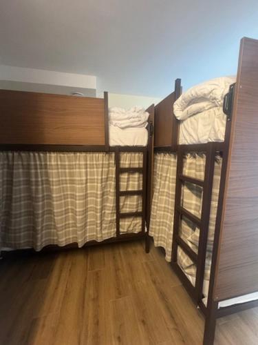 two bunk beds in a room with wooden floors at El Albuergo in Llanes