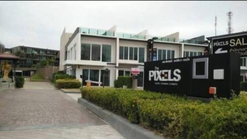 a large building with a sign in front of it at Phuket, The Pixcel Cape Panwa Condo in Ban Ao Makham