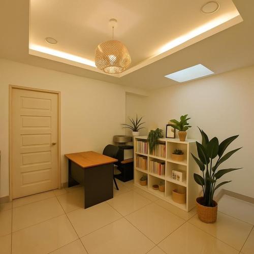 an office with a desk and a book shelf at Cozy Suite for 2-6 pax near Kek Lok Si, Penang Hill, Sunshine Central in Ayer Itam