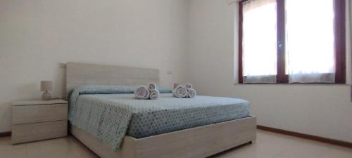 a bedroom with a bed with two towels on it at Sole e Luna in San Vito
