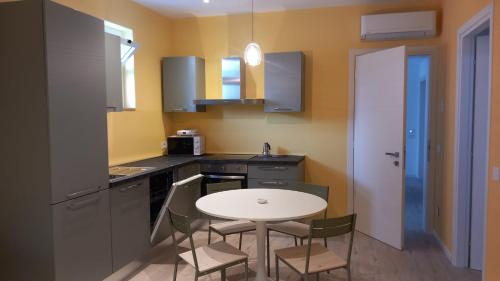 a small kitchen with a table and chairs in it at Appartamento Stella Marina in Gabicce Mare