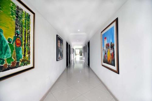 a hallway with paintings on the walls of a building at Chakaville Beach Resort in Iberekodo