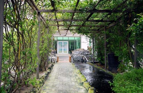 a covered walkway leading to a building with a glass door at Chakaville Beach Resort in Iberekodo
