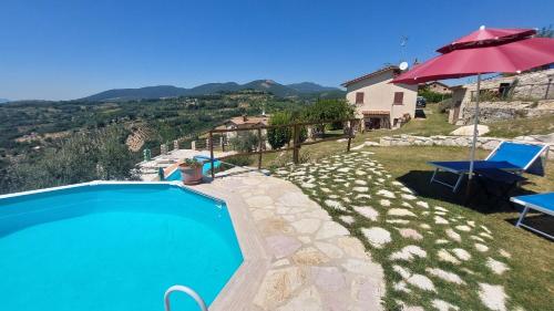 una piscina con dos sillas y una sombrilla en Casaletto, en Casaprota