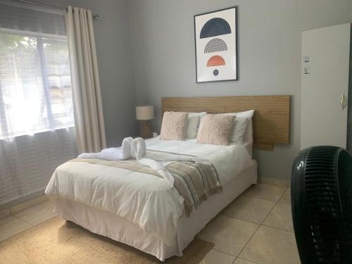 a bedroom with a large bed with towels on it at Maita Guest in Cape Town