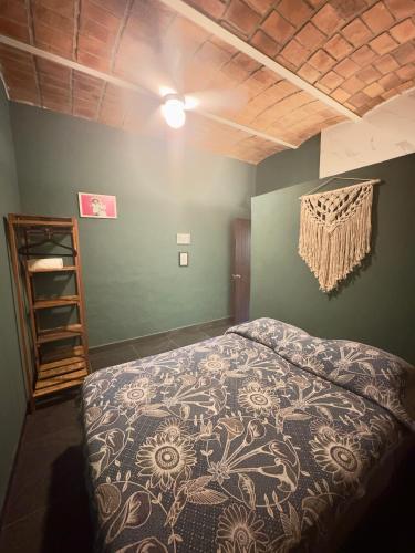 a bedroom with a bed in a room with a wooden ceiling at Apartamento Parota # in Sayulita