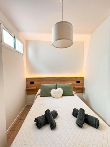 a bedroom with a bed with four black pillows at Loft Molino de Erillas in Alora