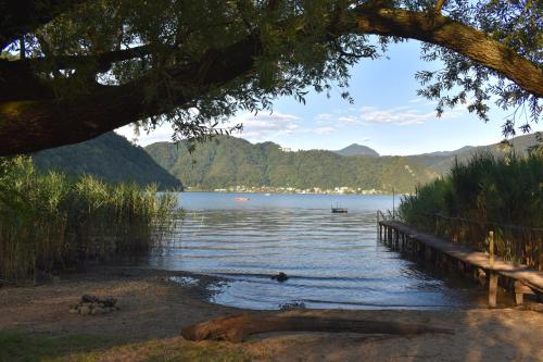 a view of a body of water with a dock at Lago di Lugano - Casa Cecilia in Lavena Ponte Tresa
