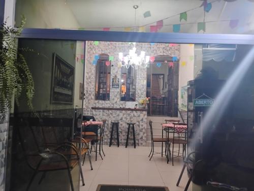 a restaurant with tables and chairs in a room at Pousada San Valen in Aparecida