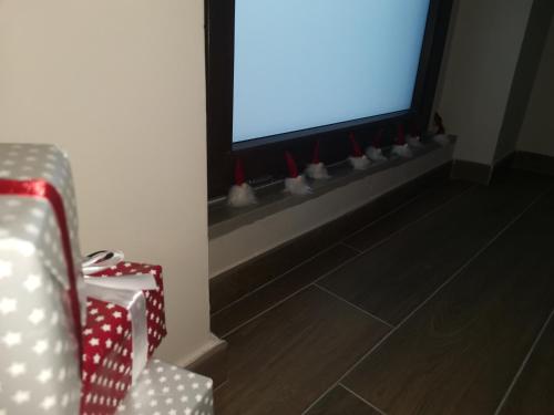 a room with a television with red and white decorations at La Casa di Marta in Ateleta