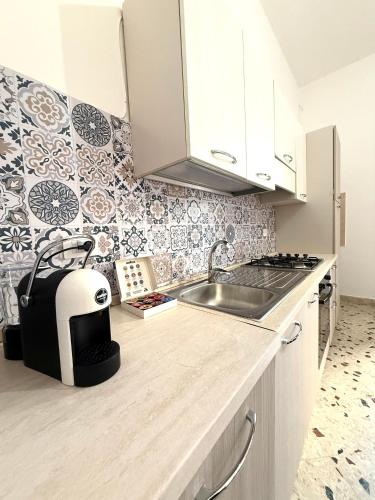 a kitchen with a sink and a toaster on a counter at Dimora Anastasia - Alloggio nel cuore di Balestrate in Balestrate