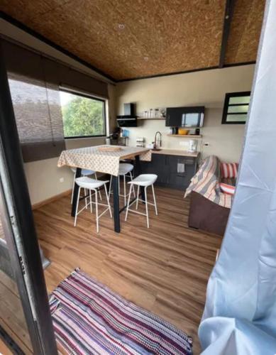a kitchen and living room of a tiny house at Le Pistachier in Saint-Leu