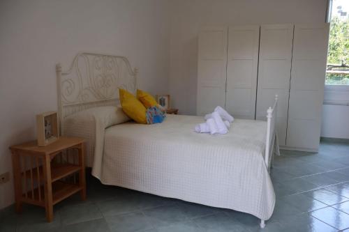 a bedroom with a bed with towels on it at Casa Flaùti Sorrento in Piano di Sorrento