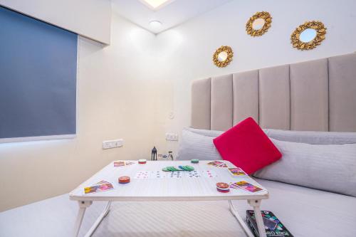 a room with a table in front of a bed at Skylight BnB F203 - 2BHK with pool near Candolim beach in Candolim