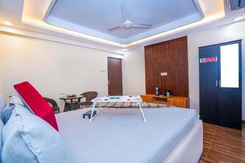 a bedroom with a large white bed with a ceiling at Skylight BnB F203 - 2BHK with pool near Candolim beach in Candolim