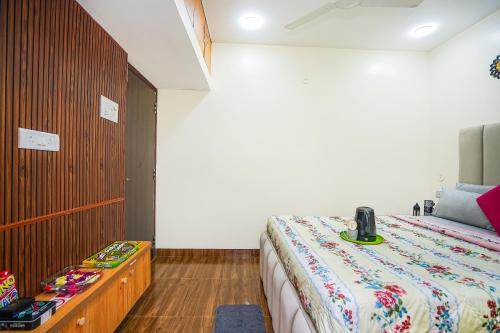 a bedroom with a bed and a dresser at Skylight BnB F203 - 2BHK with pool near Candolim beach in Candolim