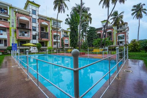 a pool in front of some apartment buildings at Skylight BnB F203 - 2BHK with pool near Candolim beach in Candolim