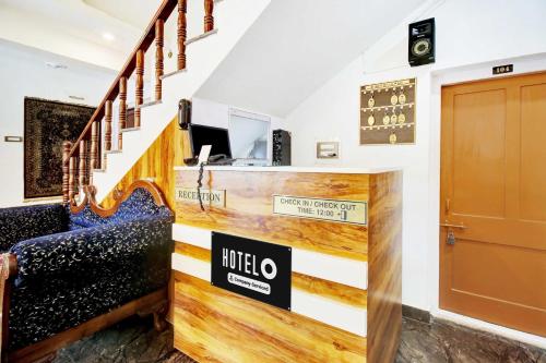 a lobby of a hotel with stairs and a sign at Hotel O Dal Lake in Srinagar