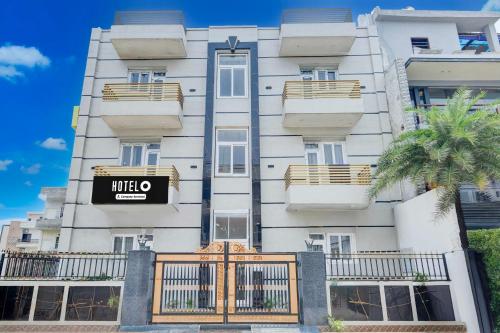 a white building with a mitzo sign on it at Hotel O Phagwara Near LPU Law Gate in Phagwāra