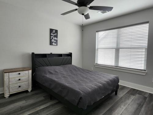 a bedroom with a bed and a ceiling fan at Modern Retreat in Sherman in Sherman
