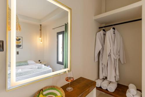 a bathroom with a mirror and a bed in a room at Villa Eira, Luxury Retreat Kastraki Naxos in Kastraki Naxou