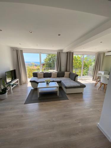 a living room with a couch and a table at Apartman Lana in Sutomore
