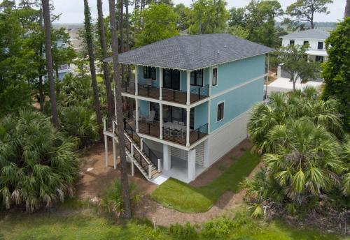 an aerial view of a house with trees at Experience Modern Coastal Living in this Beautifully Designed 4-Bed, 4-Bath Home in Fripp Island