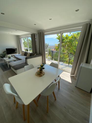 a living room with a white table and chairs at Apartman Lana in Sutomore
