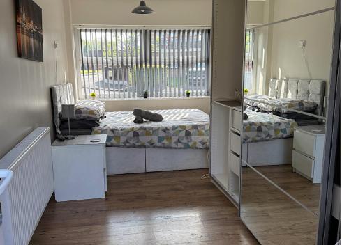 a room with two beds and a mirror at Chateau julie in Liverpool