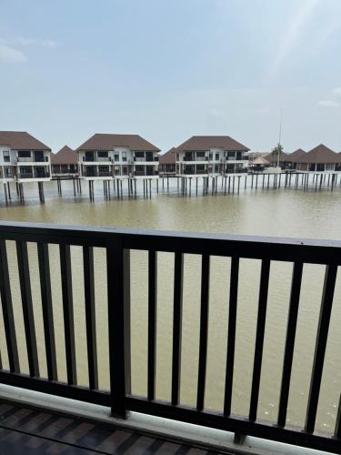 a body of water with houses in the background at Avani Sepang Goldcoast Resort in Tanjong Sepat