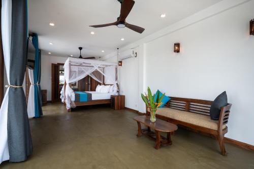 a bedroom with a bed with a ceiling fan at Tangalle Villa in Tangalle