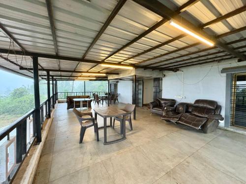 a large living room with a table and chairs at Zenstays Villa Igatpuri in Igatpuri
