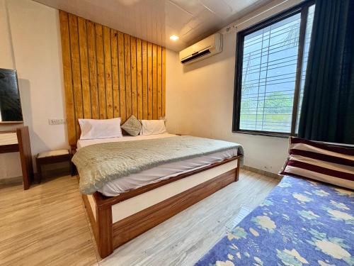 a small bedroom with a bed and a window at Zenstays Villa Igatpuri in Igatpuri