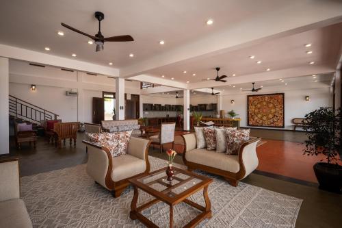 a living room with couches and a table at Tangalle Villa in Tangalle