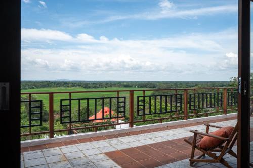a room with a balcony with a view of a field at Tangalle Villa in Tangalle