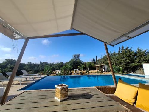 a view of the pool from the pavilion of a villa at Cosy Guest House - Villa das Alfarrobas in Algoz