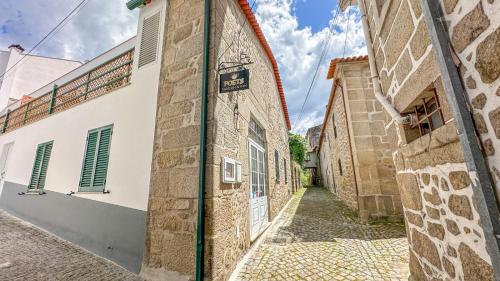 a street in an old town with buildings at Poets Tavern & Inn in Avô