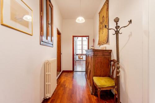 a living room with a wooden floor and a chair at Signoria Vista by Halldis in Florence