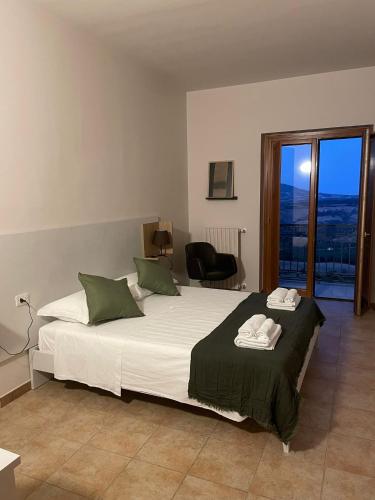 a bedroom with a large white bed with green pillows at Numa Living in Rapone