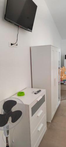 a room with a desk with a chair and a tv at Agriturismoteo in Bernalda
