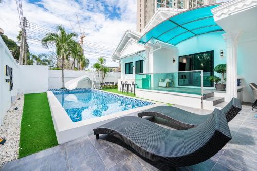 a villa with a swimming pool and a house at Villa 35 Wongamart in North Pattaya