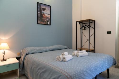 a bedroom with two beds with towels on them at Palia's Hotel in Laino Borgo