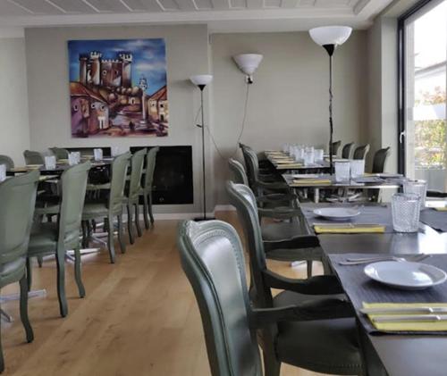 a dining room with tables and chairs and a tv at Hotel Medieval® de Penedono in Penedono
