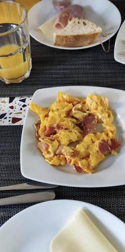 a plate of breakfast food on a table at Hotel Medieval® de Penedono in Penedono