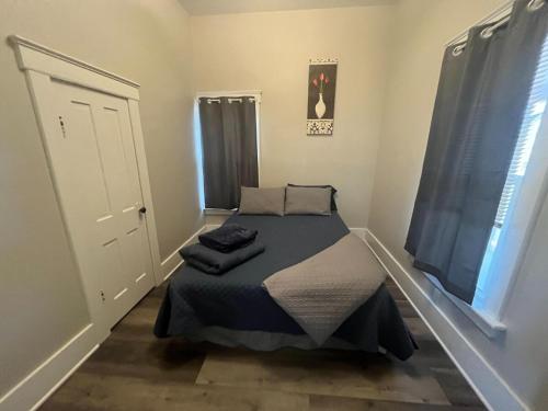a small bed in a room with a window at Heart City Cozy in Valentine