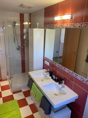 a bathroom with a sink and a shower at Hotel Erlebniswelt Stocker in Schladming