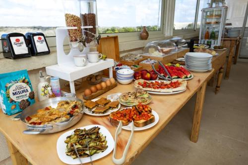 a table with many plates of food on it at Puloni in Otranto