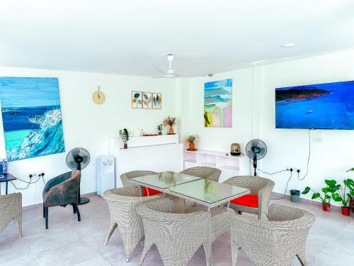 a dining room with a table and chairs at SunSeaSurf Maldives in Thulusdhoo
