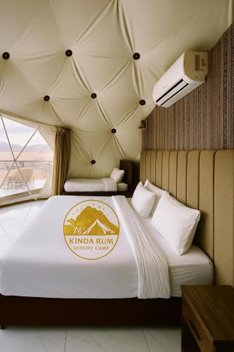 a hotel room with two beds in a tent at Kinda Rum Luxury Camp in Wadi Rum